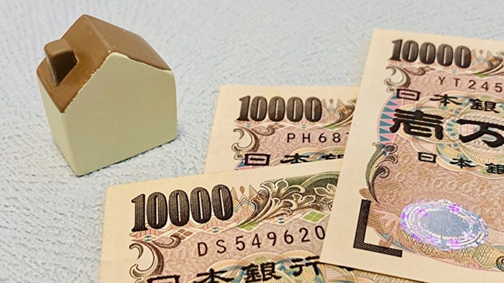 家の模型と一万円札